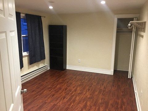 a living room with a hard wood floor and a closet